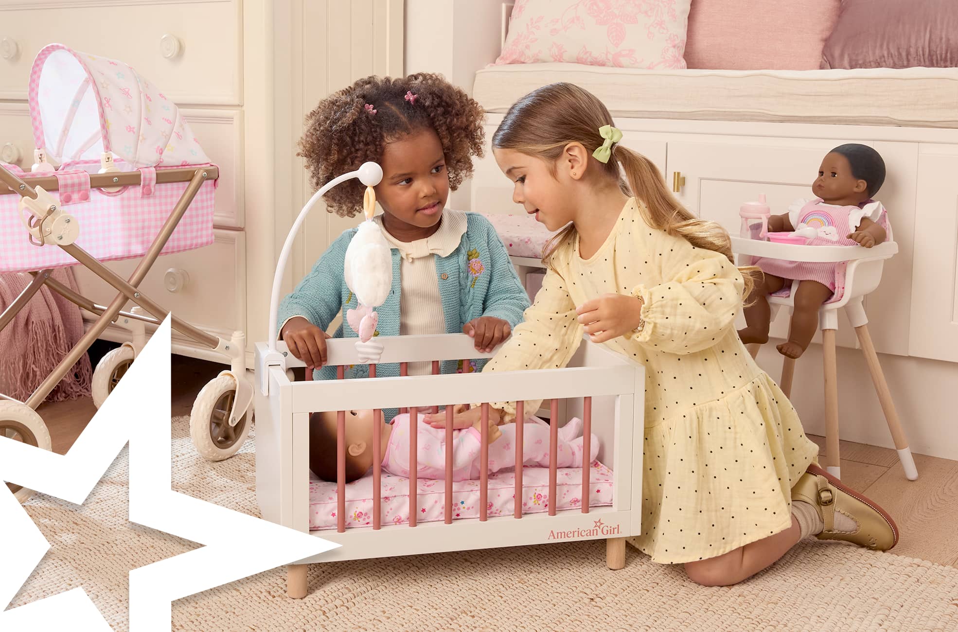 Two girls with Bitty Baby in a crib