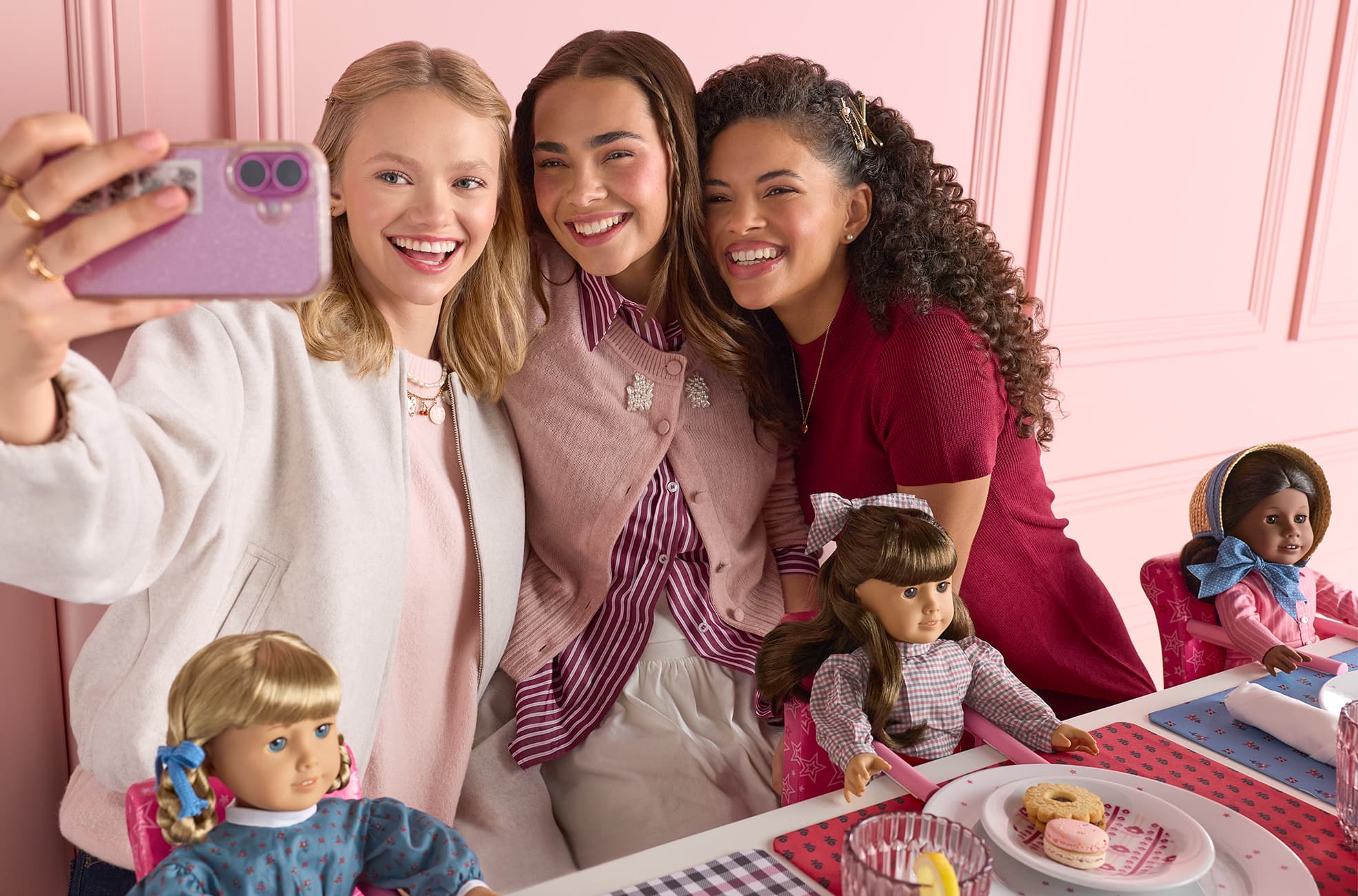 Image of young adults taking a selfie with their historical character dolls