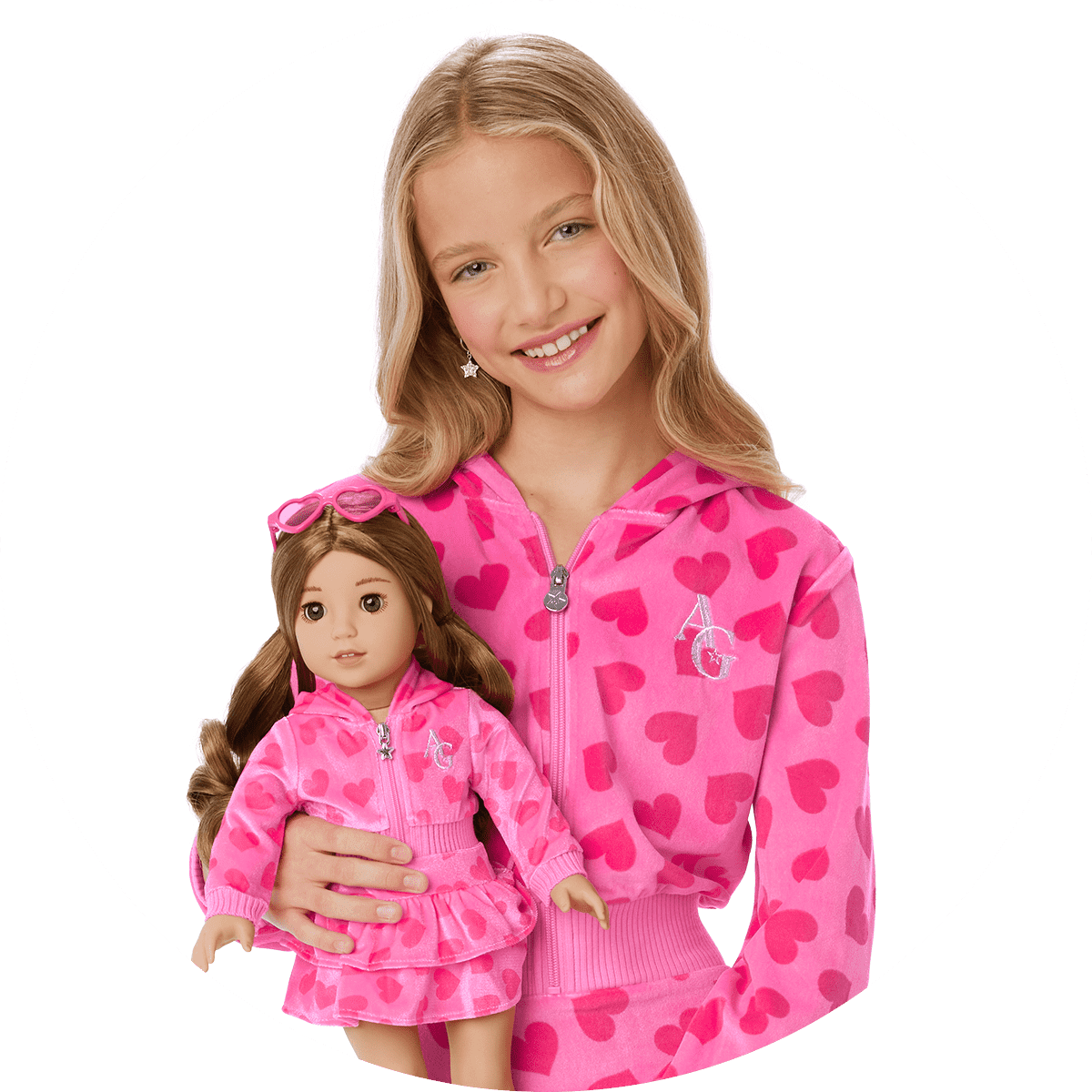 Girl in matching pink sweatsuit with doll