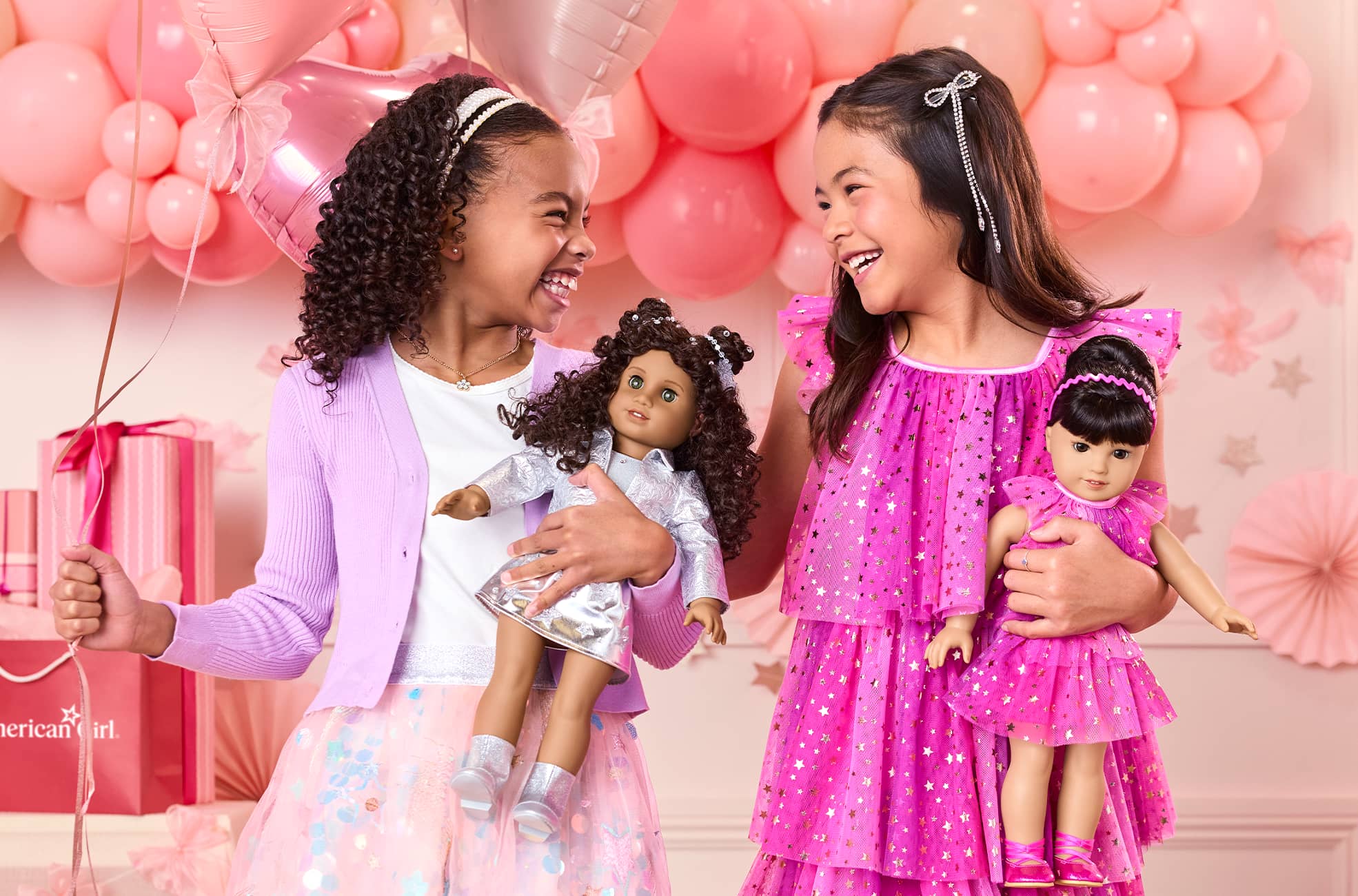 Image of young girls with their matching dolls
