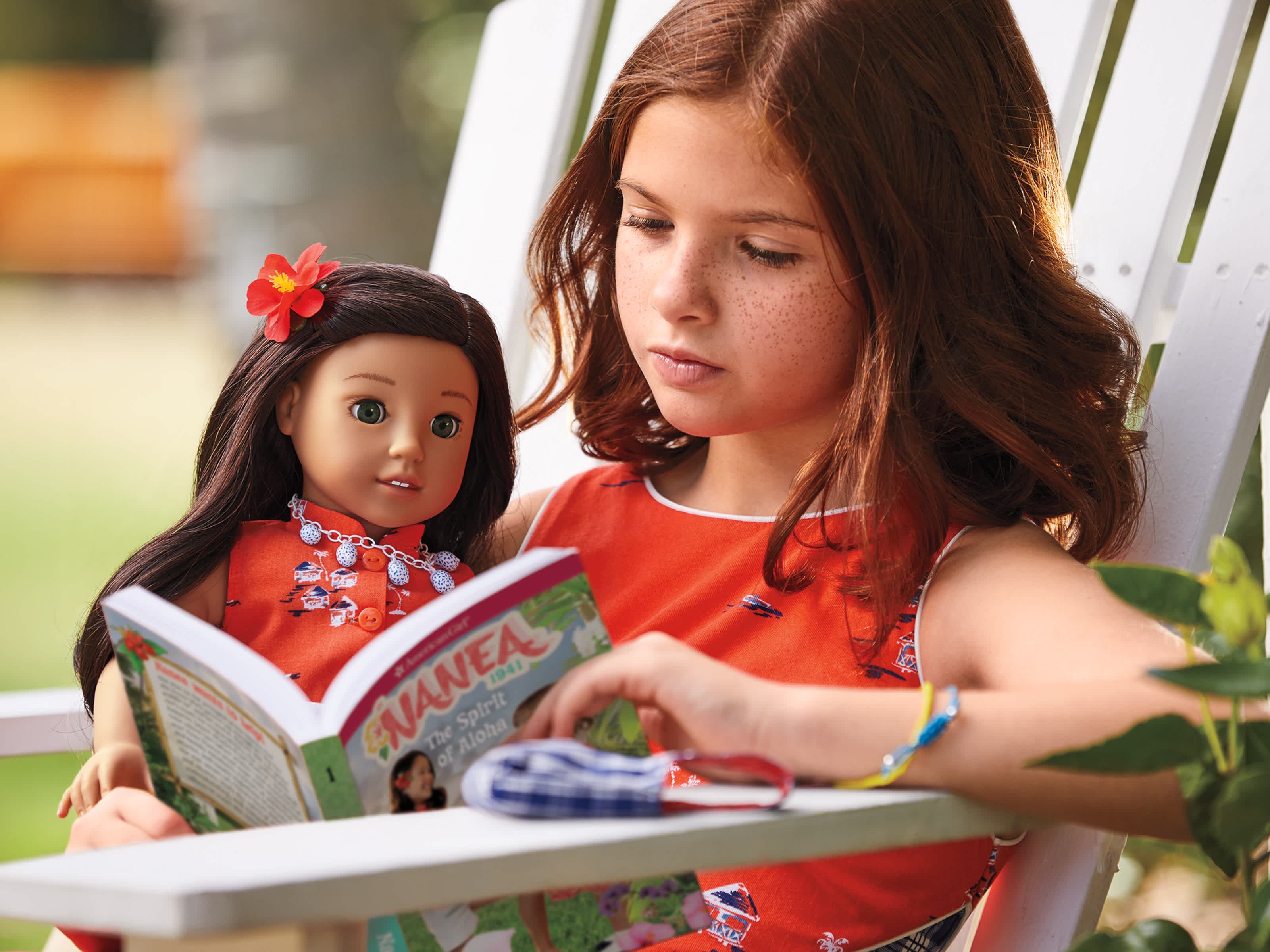 Girl reading The Spirit of Aloha book with Nanea doll