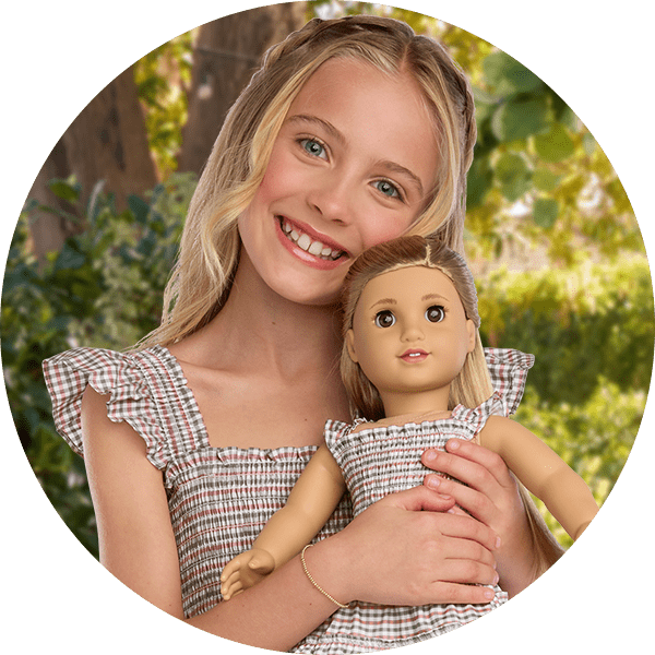 Young girl and doll in a matching dress set