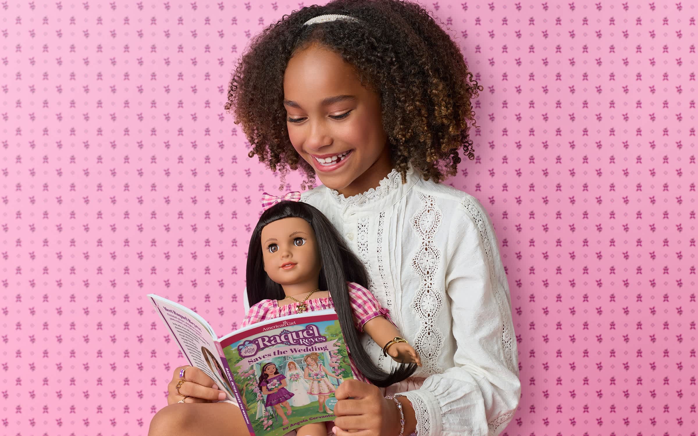 Image of girl holding and reading to Raquel Reyes doll