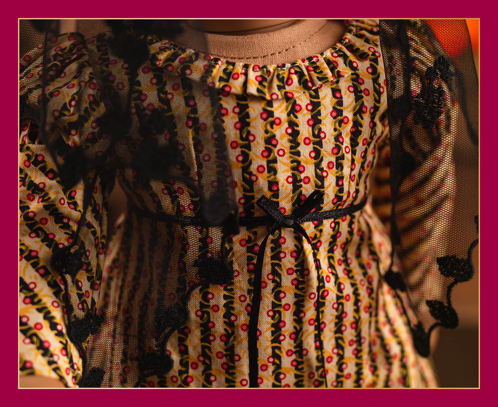 Close up of ruffled collar, Regency-style sleeves and empire waist on Josefina's dress