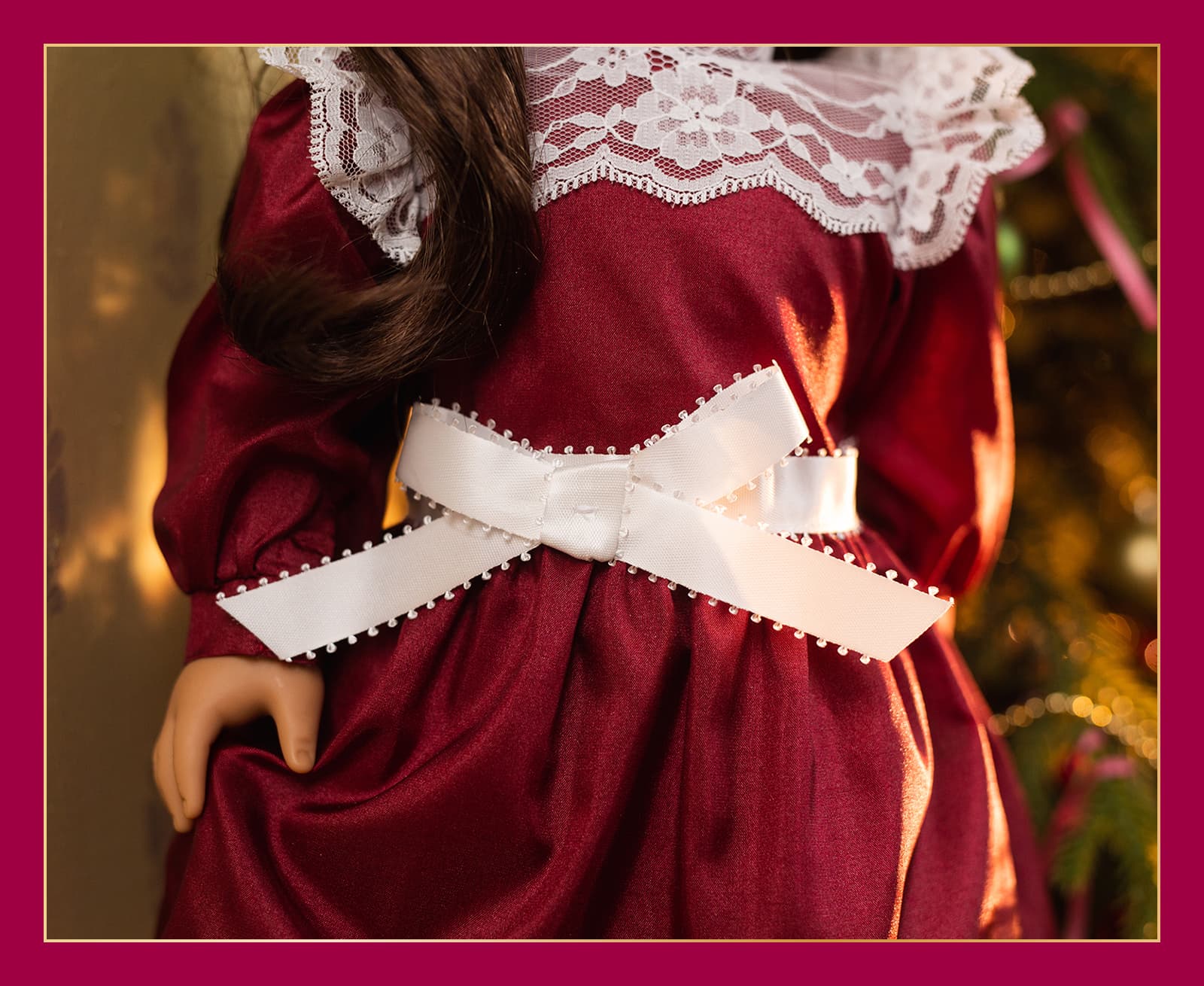 Close up of lace collar, satin bow and long puffed sleeves on Samantha's dress