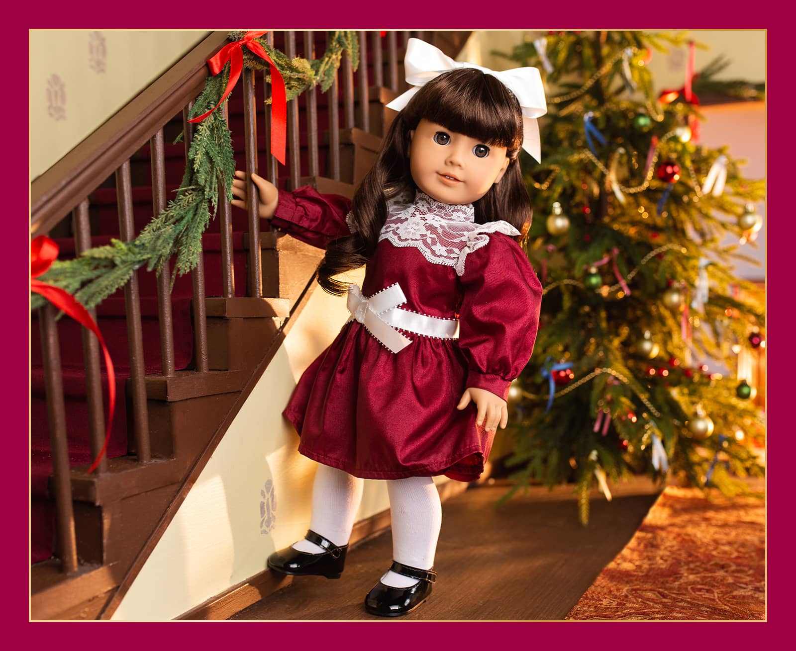 Samantha holding onto staircase in festive burgundy dress