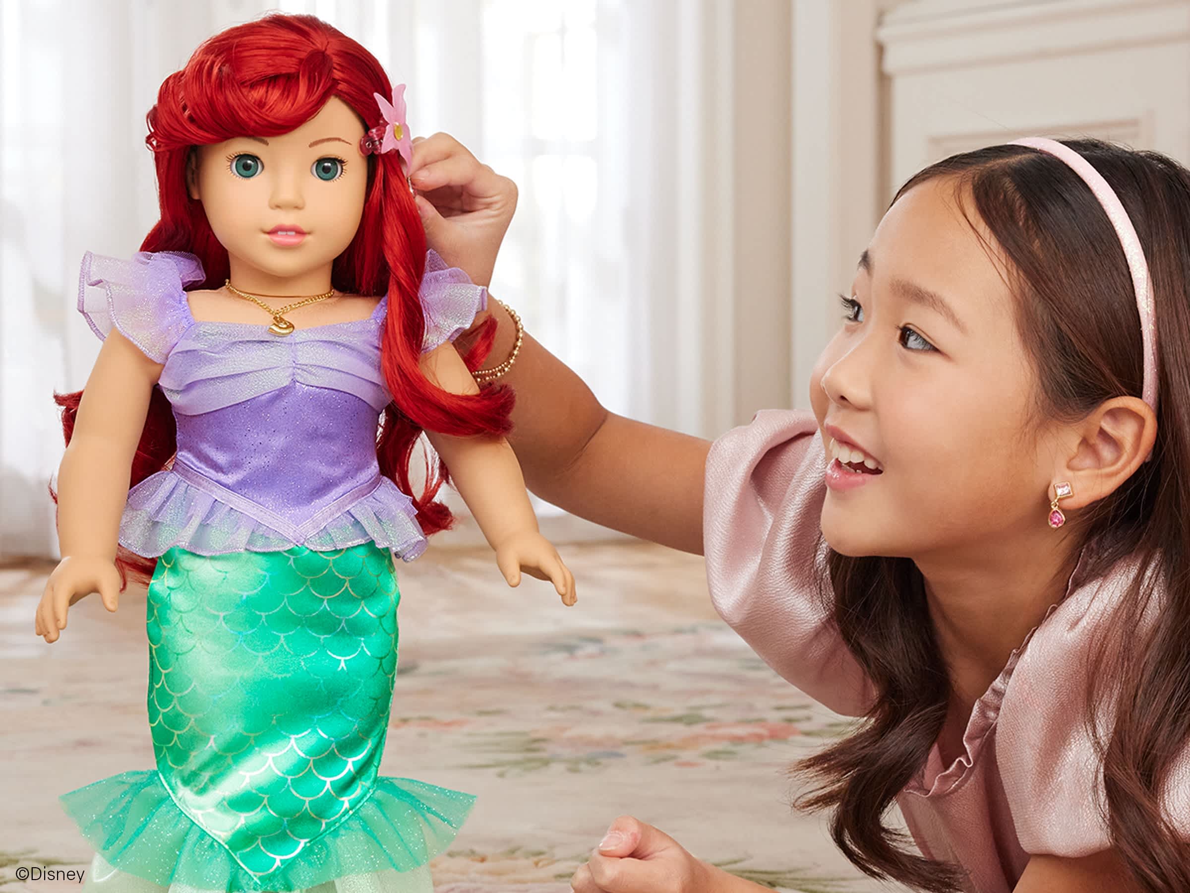 Girl playing with Disney Princess Doll, Ariel