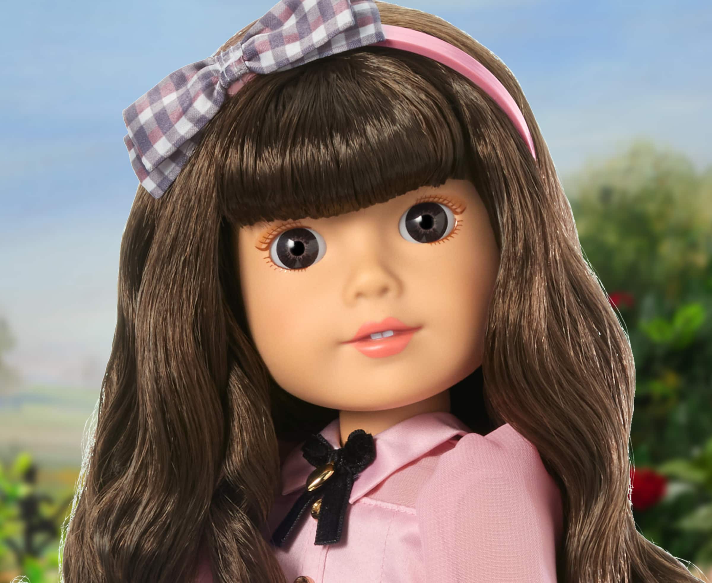 Close up image of Modern Era American Girl doll, Samantha, smiling