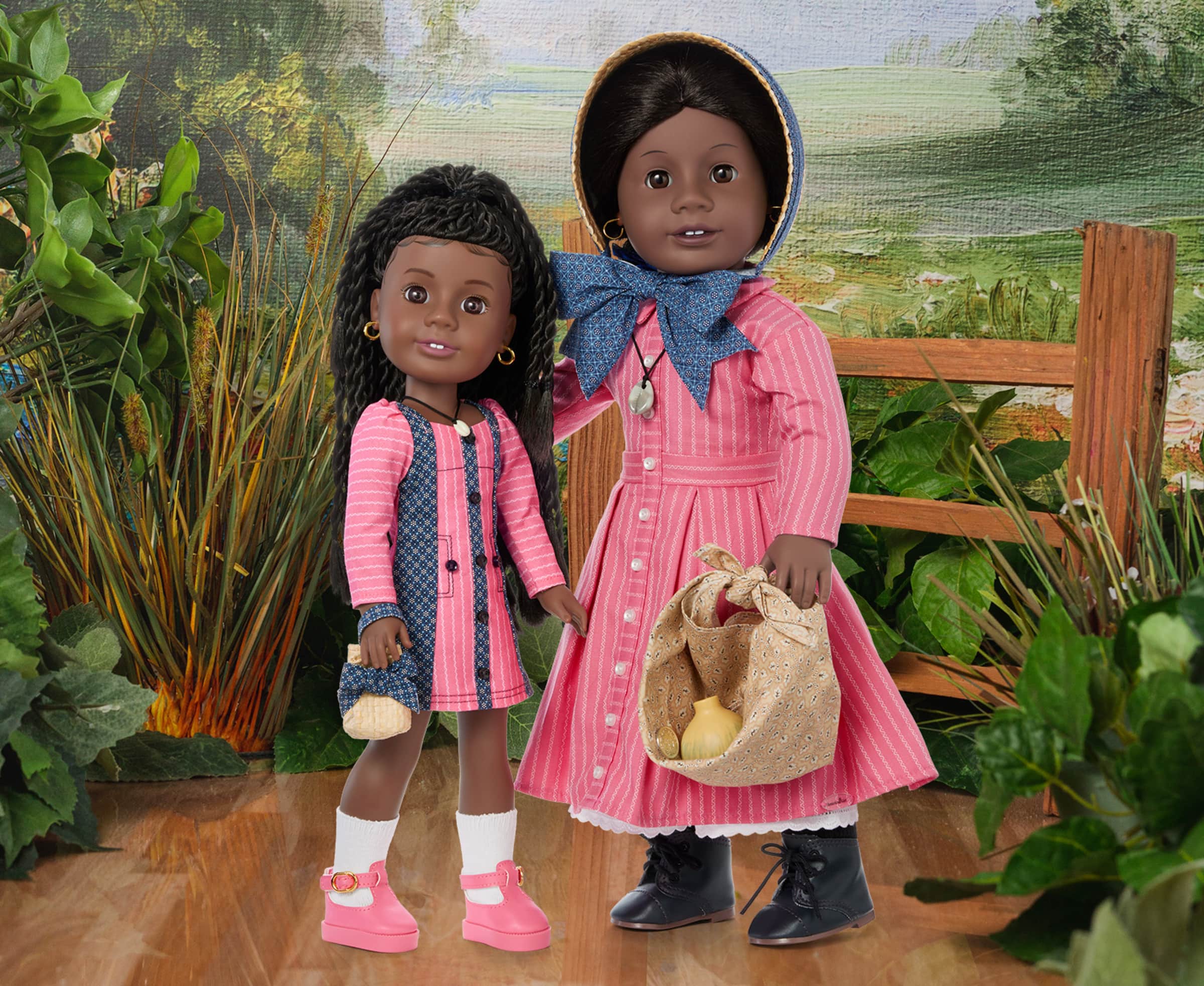 American Girl Addy doll, standing next to Modern Era Addy