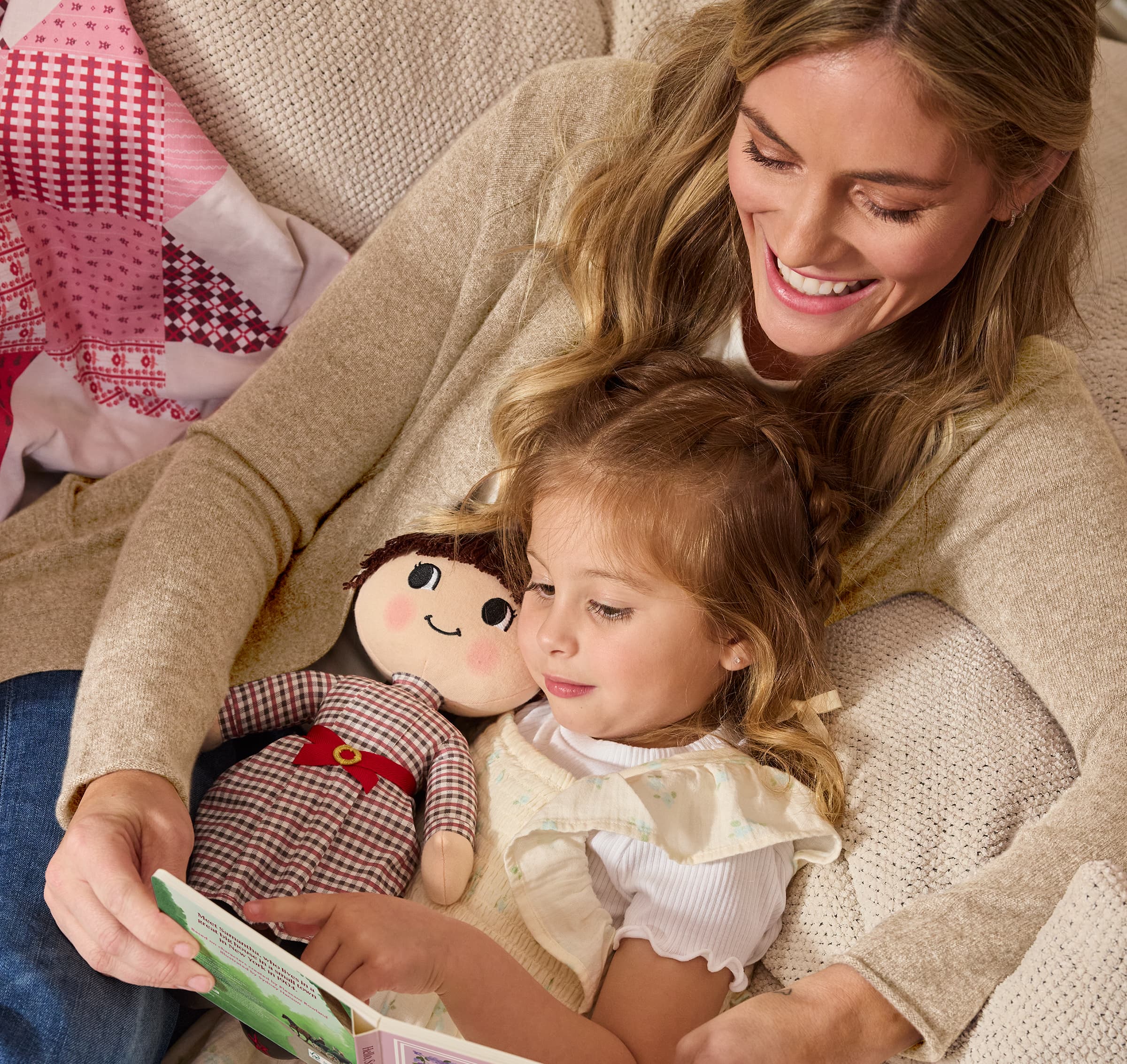 Girl holding Samantha Parkington plush doll