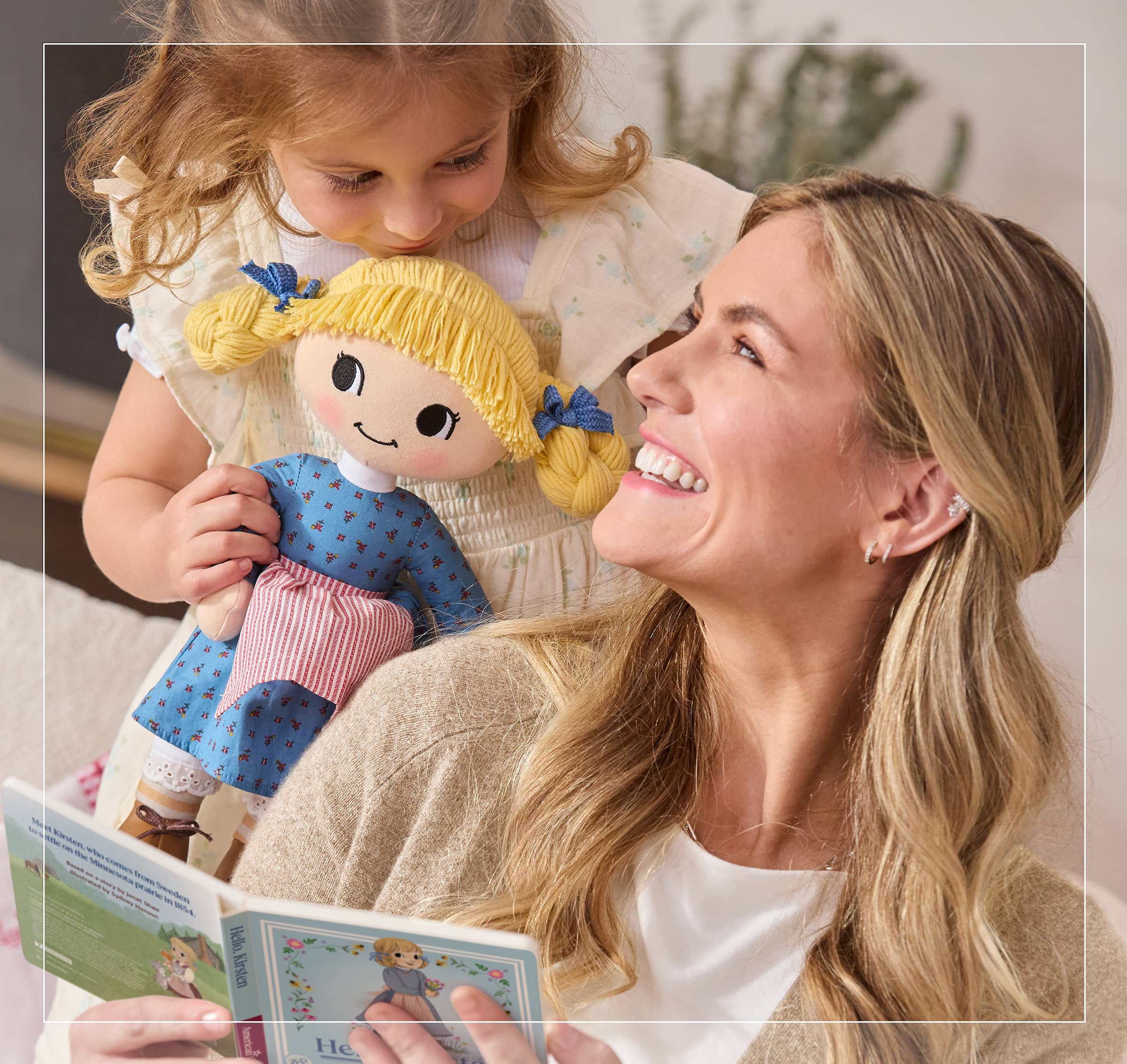 Girl holding Kirsten Larson plush doll